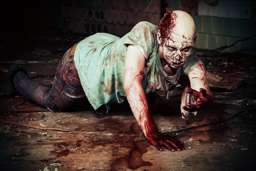 Horrible scary zombie man on the ruins of an old house. Horror. Halloween.